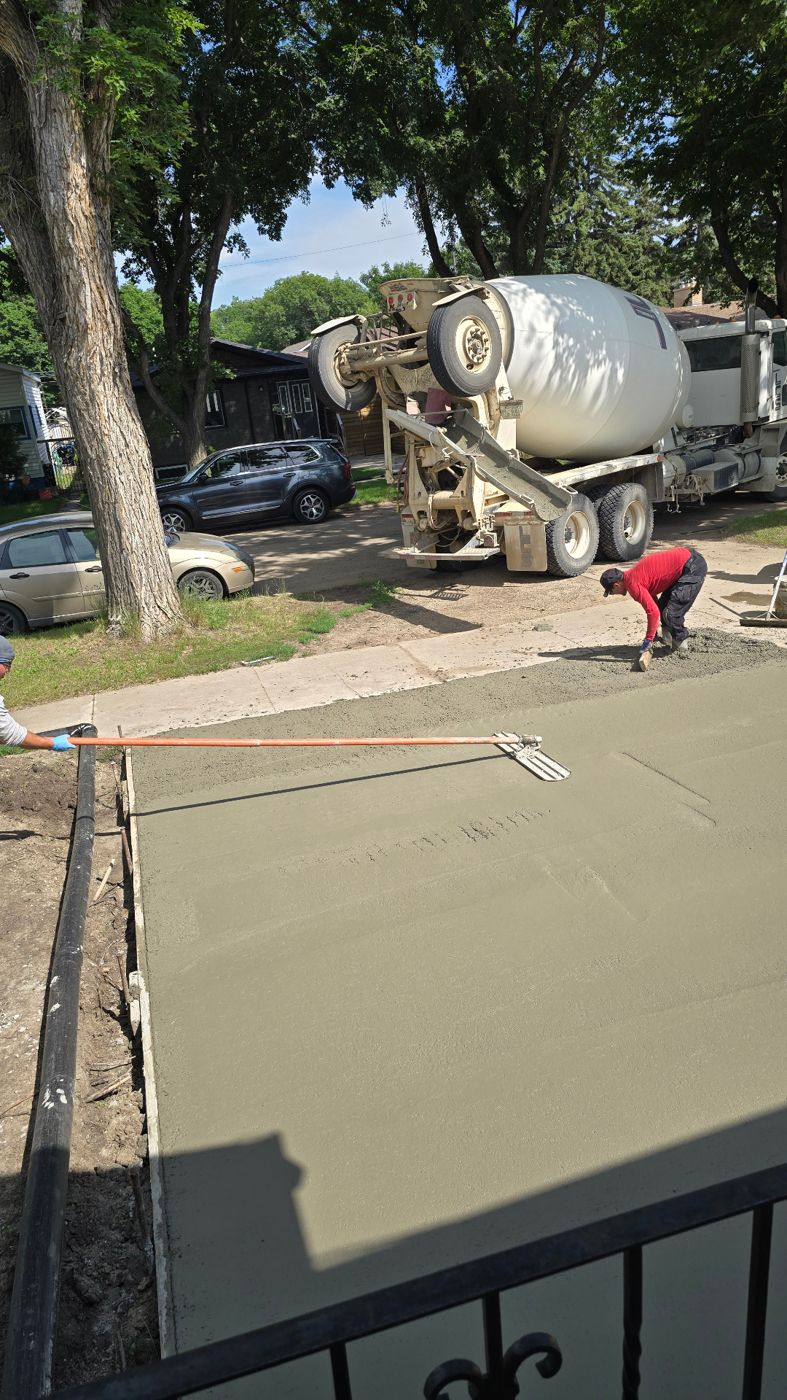 AB Concrete Finishing crew bull-floating a freshly poured driveway in Saskatoon