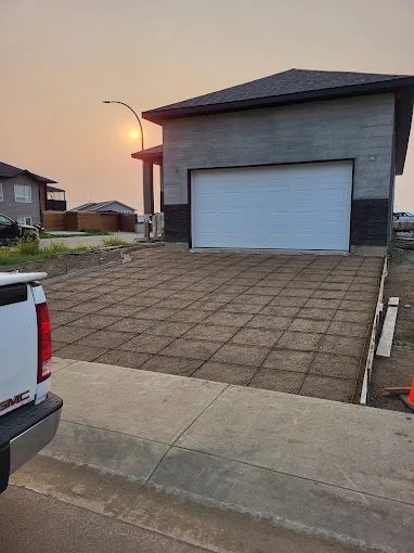 Cut-jointed concrete driveway at sunset in a Saskatoon subdivision