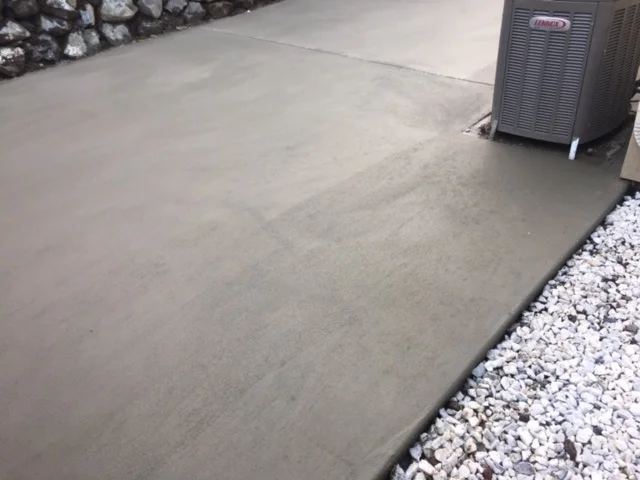Smooth-troweled concrete pad next to a home