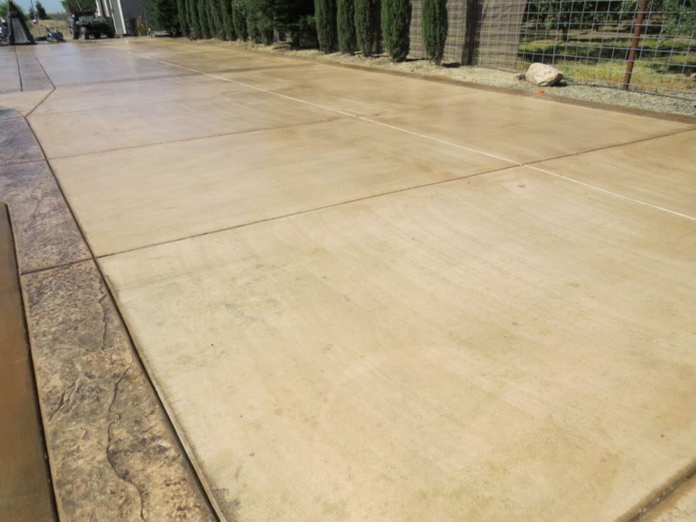 Warm-toned coloured concrete driveway
