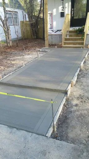 Concrete front walkway leading to the porch of a Saskatoon home