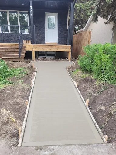 Smooth-finish concrete front walkway with wood formwork in place