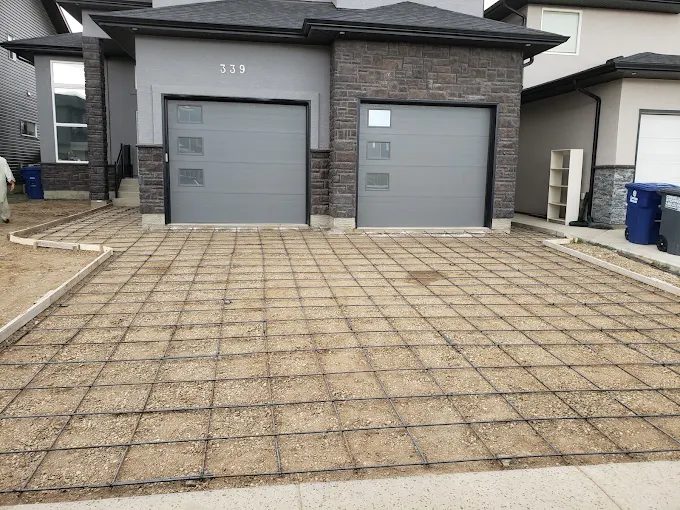 Reinforced concrete driveway prepped with rebar grid before pour